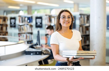 Intelligent Latina girl hold academic books in the college library - Powered by Shutterstock - Get 15% off with code: PIKWIZARD15
