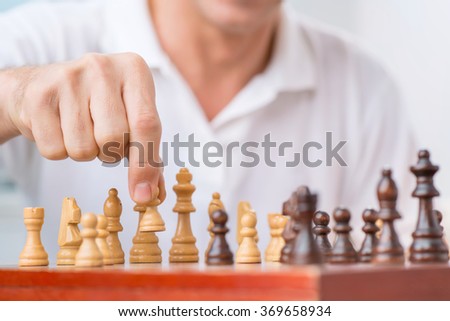 Intelligent man playing chess 