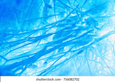 Intense bright blue organic irregular background with connected synapsis. Extreme macro full frame horizontal crop.
