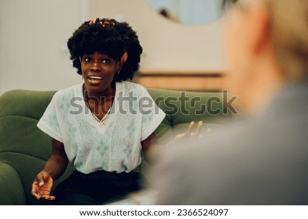 An intense client is explaining her problems in a session with a psychotherapist. An african american woman is sitting in the office with a psychotherapist and discussing issues.