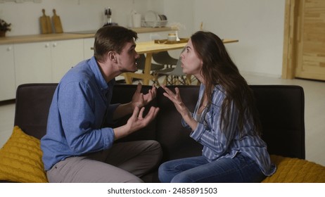 Intense Domestic Confrontation: Young Couple's Argument on Sofa in Home Setting - Powered by Shutterstock