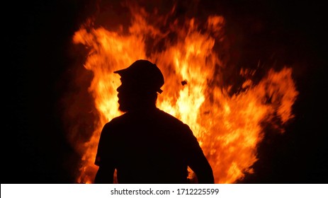 intense fire with the profile silhouette of a person without a cap. warm backlight. intense red and black image - Powered by Shutterstock