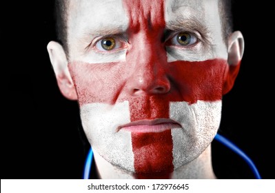 Intense Stare From A Football Fan With Their Face Painted With The English Flag.