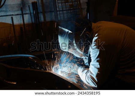 Intense Welding Sparks with Protective Gear in Workshop
