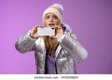Intense Worried Blond Girl Holding Mobile Phone Horizontal Recording Video Capture Moment Share Friends Internet Blog Using Smartphone Camera Shoot Photograph Standing Serious Purple Background