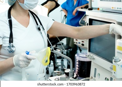 An Intensive Care Physician Prepares Equipment For Artificial Ventilation Of The Lungs For Intubation In A Critical Patient With Coronavirus. COVID-19 Epidemic Affecting The Respiratory System.