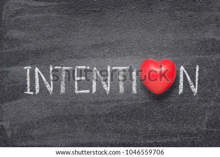 intention word handwritten on chalkboard with red heart symbol instead of O
