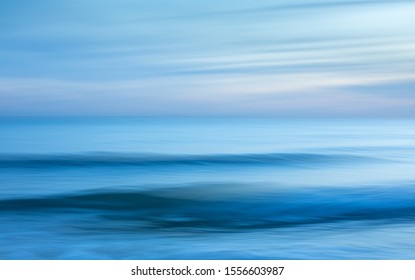 Intentional camera movement creating a dreamy, blurred effect of the sea at Brighton and Hove, East Sussex.
