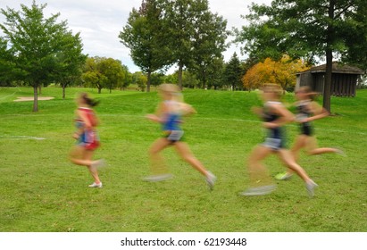 Intentionally Blurred Image Of Girls Running At A High School Cross Country Meet