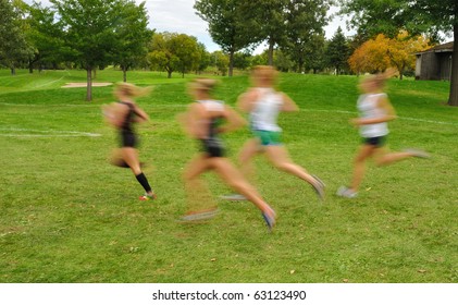 Intentionally Blurred Image Of Girls Running At A High School Cross Country Meet