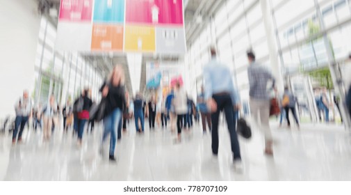 Intentionally Blurred People Walking Trade Show Floor