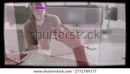 Interacting woman's ringed hand in maroon sleeve gesturing over AR panel in office, tablet nearby. Augmentedreality, collaboration, teamwork, translucent, annotations, gridlines, magenta