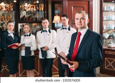 The Interaction Of The Staff. Hotel Or Restaurant Manager And His Staff In Kitchen. Interacting To Head Chef In Commercial Kitchen