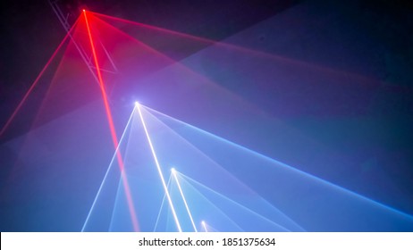 Interactive exposition in modern science museum or exhibition: bright laser show installation with color rays or beams in dark room. Performance, technology, visuals, digital, contemporary art concept