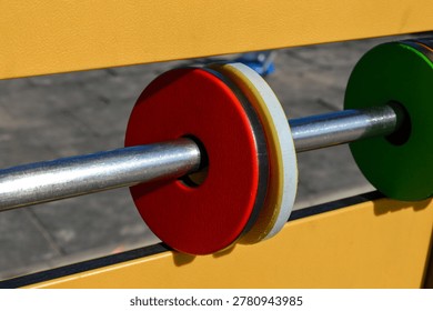 Interactive playground activity panel with rotating elements, close up. Sensory play equipment, child development, inclusive playground and educational activity concept.