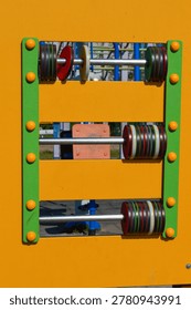 Interactive playground activity panel with rotating elements, close up. Sensory play equipment, child development, inclusive playground and educational activity concept.