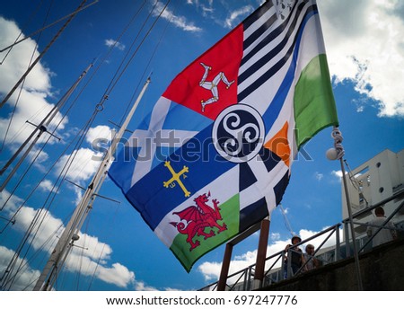 Interceltique flag, masts and blue sky in the port of Lorient, Brittany in France during the Interceltique festival of Celtic music and culture
