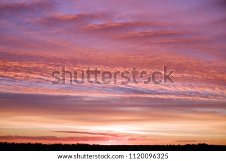Interchange of the highway. Dramatic sky, fiery sunset. The lights on the road.