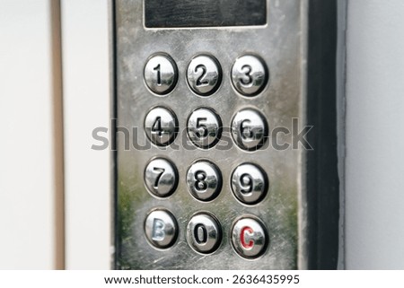intercom buttons of apartment building on street, numbers from one to nine