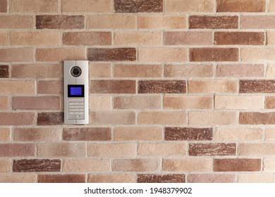 intercom with camera on brick wall, close up and copy space