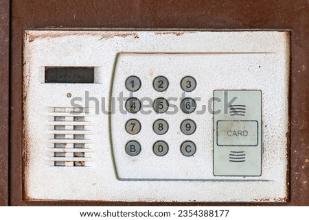 Intercom code lock on the front door. Background with selective focus and copy space for text
