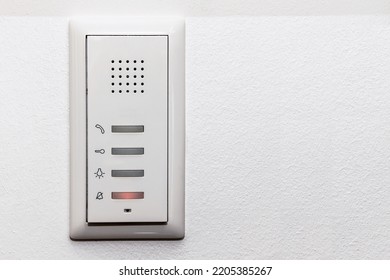 Intercom On White Wall With Microphone. Modern Door Bell, Electronic Lock Inside Apartment. Copy Space 