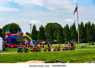 Intercourse, PA, USA – June 19, 2021: An Amish man walks with children in a park at the Intercourse Heritage Days, an annual community festival in rural Lancaster County, Pennsylvania.