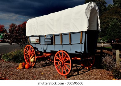 Intercourse, Pennsylvania - October 13, 2015:  A Pennsylvania conestoga covered wagon with autumn pumpkins and gourds at Kitchen Kettle Village