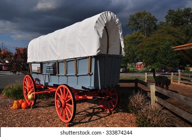 Intercourse, Pennsylvania - October 13, 2015:  A vintage Pennsylvania conestoga covered wagon with autumn pumpkins and gourds at Kitchen Kettle Village *