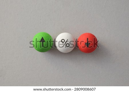Interest rate comparison with increase decrease and percentage symbols on wooden balls