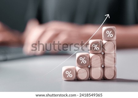 Interest rate concept. Wooden block with percentage symbol and up arrow for Interest rate and dividend concept, return on stocks and mutual funds, long term investment for retirement.