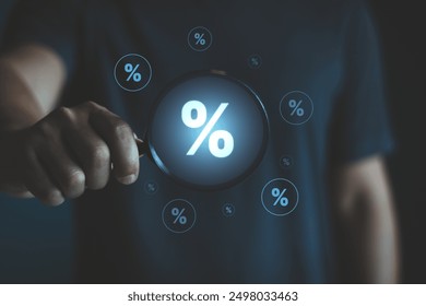 Interest Rate and Dividend Concept. Business people hold a magnifying glass with virtual percentage symbols surrounding it, representing interest rate and dividend concepts in financial analysis. - Powered by Shutterstock