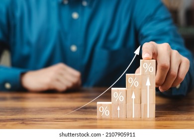 Interest rate and dividend concept, wooden block with percentage symbol and up arrow, return on stocks and mutual funds, long term investment for retirement. - Shutterstock ID 2107905911