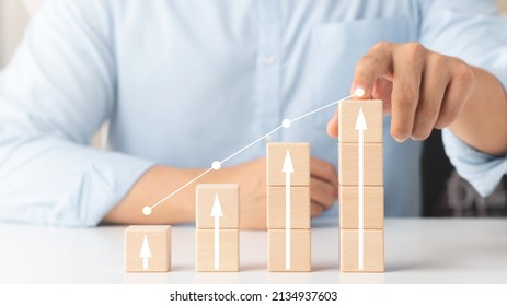 Interest rate and dividend concept, wooden block with percentage symbol and up arrow, return on stocks and mutual funds, long term investment for retirement. - Shutterstock ID 2134937603