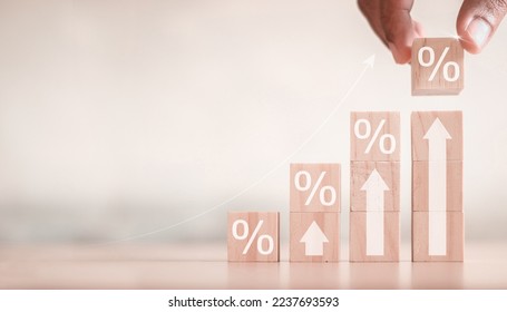 Interest rate and dividend concept, wooden block with percentage symbol and up arrow, return on stocks and mutual funds, long term investment for retirement. - Shutterstock ID 2237693593