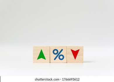 Interest rate financial and mortgage rates concept. Wooden cube block with icon percentage symbol and arrow up and down direction