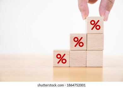 Interest Rate Financial And Mortgage Rates Concept. Hand Putting Wood Cube Block Increasing On Top With Icon Percentage Symbol Upward Direction