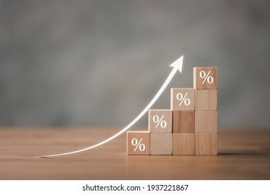Interest rate financial and mortgage rates concept. Wooden blocks with Icon percentage symbol and arrow pointing up. The economy is improving. - Shutterstock ID 1937221867