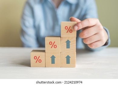 Interest rate financial and mortgage rates concept. Hand putting wood cube block increasing on top with icon percentage symbol and arrow upward direction - Shutterstock ID 2124210974