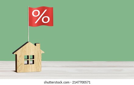 Interest Rate Financial And Mortgage Rates Concept. Wooden House And Flag With Percent Sign