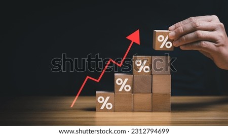 Interest rate financial and mortgage rates concept. Wooden blocks with Icon percentage symbol and arrow pointing up. company business growth and sales, interest rate, tax, real estate, inflation