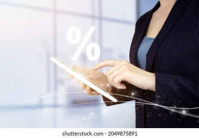 Interest rate, financial, ranking and mortgage rates concept. Hand touch white tablet with digital hologram percent sign on light blurred background. Discount commission presented by percent sign - Shutterstock ID 2049875891
