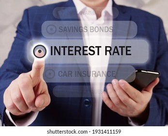  INTEREST RATE Text In List. Marketing Expert Looking For Something At Smartphone. An interest Rate is Defined As The Proportion Of An Amount Loaned Which A Lender Charges As interest to The Borrower
