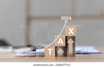 Interest Rates, Inflation and Taxes Place the wooden block on the coin with the Tax 2024 icon with an up arrow on the coin. investment concept and interest rate Financial and statistical graph
