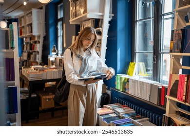 Interested focused middle aged woman spending free leisure time choosing book shopping in bookstore. Thoughtful mature female with book in hands standing near bookcase in library, enjoying reading. - Powered by Shutterstock