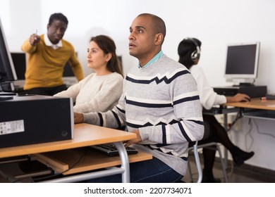 Interested Latin American Man Studying In Computer Class In Public Library..