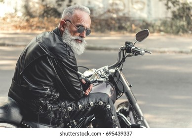 Interested Old Man Ready For Riding Motorcycle