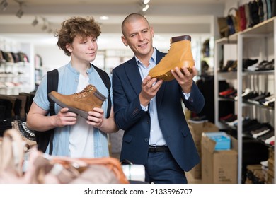 Interested Young Man And Teenager Looking For Comfortable Demi-season Mens Shoes In Modern Shoe Store.