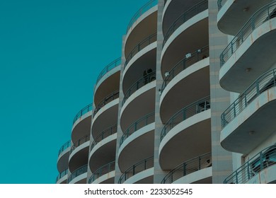 Interesting arhitectural round elements of building or hotel. Multiple balconies forming an interesting view.