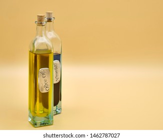 Interesting bottle with cork stopper of olive oil with a similar type bottle of balsamic vinigar in the background. - Powered by Shutterstock